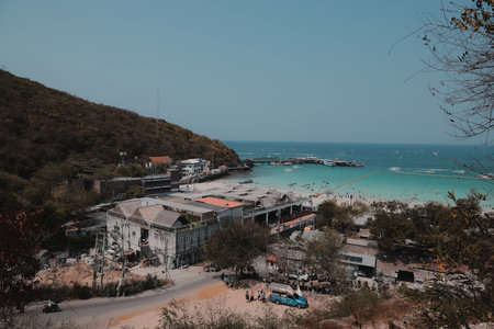 Experience the breathtaking coastal view featuring boats floating gently on clear watersの写真素材