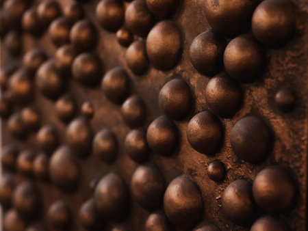 A CloseUp of a Detailed Textured Metal Surface Featuring Raised Bumps and Patternsの写真素材