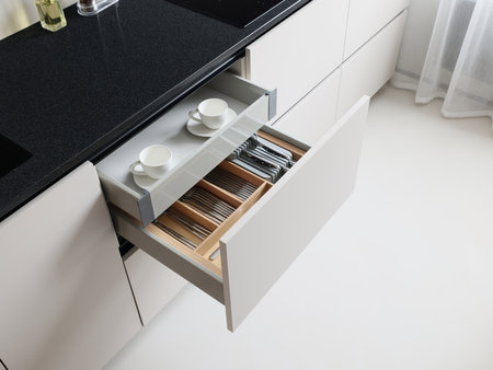 Modern Kitchen Drawer Equipped with Various Tableware and Essential Utensils for Useの写真素材