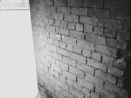 A beautifully textured brick wall illuminated with soft and gentle light creates a warm ambianceの写真素材