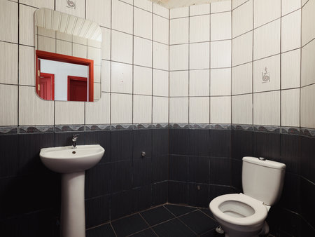 This bathroom features a simple modern design with contemporary fixtures in neutral colorsの写真素材