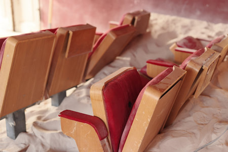 Abandoned theater seats that are covered in thick dust and have an air of nostalgia about themの写真素材