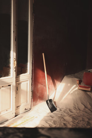 The Play of Light and Shadow in an Abandoned Room with Sand Creates a Unique Atmosphereの写真素材
