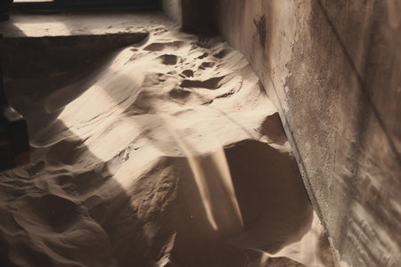 Desert Sand Flowing Smoothly Through an Abandoned Building, Creating an Intriguing Sceneの写真素材