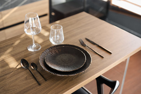 A Stylish and Elegant Dining Table Setting with Beautiful Tableware and Chic Decorの写真素材