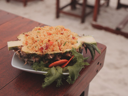 Delicious and exotic Pineapple Fried Rice beautifully presented on the dining tableの写真素材
