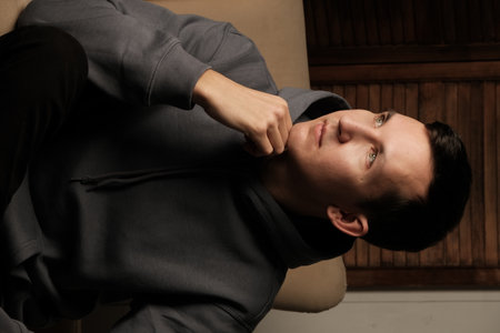 A Thoughtful Young Man Dressed in Comfortable Casual Attire, Evoking a Relaxed Atmosphere