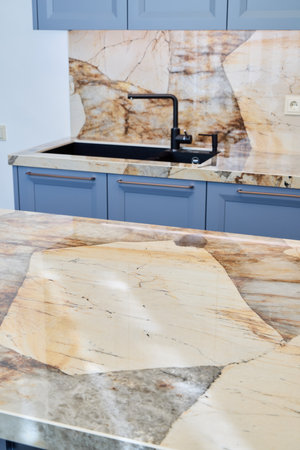 A Beautiful and Stylish Modern Kitchen Featuring Elegant Stone Countertops and Cabinets