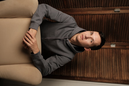 A Thoughtful Youth in a Stylish Modern Setting Ideal for Reflection and Creativity