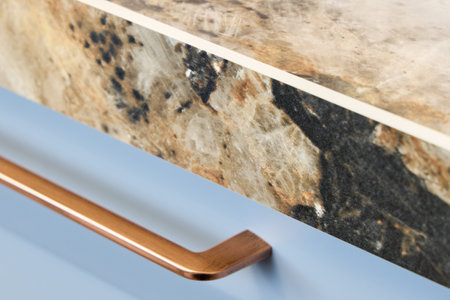 Elegant Stone Countertop with a stylish Copper Handle Design, merging beauty and function