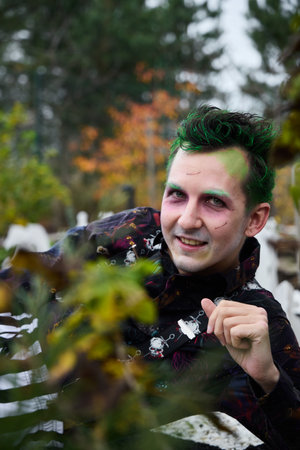 A Creative Model sporting Green Hair is captured in a Scenic Outdoor Setting full of beauty