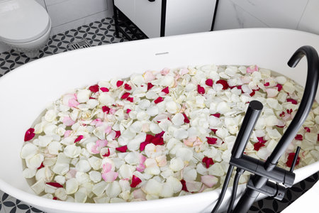 Indulge in a Luxurious Bathtub filled with Beautiful Rose Petals for Ultimate Relaxation Experienceの写真素材