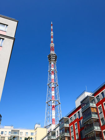 A striking Urban Communication Tower stands tall against a clear blue sky during daylight hours