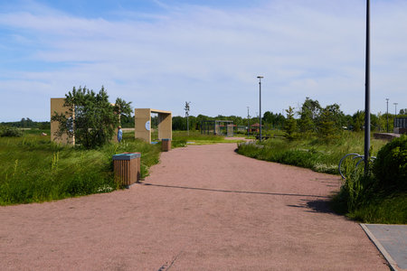 A Beautiful and Tranquil Pathway Found Within a Lush Green Landscape Awaits You Here