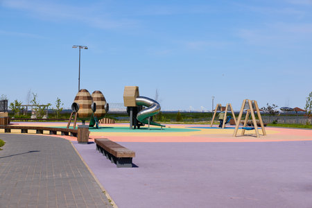 A Vibrant and Colorful Playground Featuring a Slide and Swings on a Bright Sunny Day