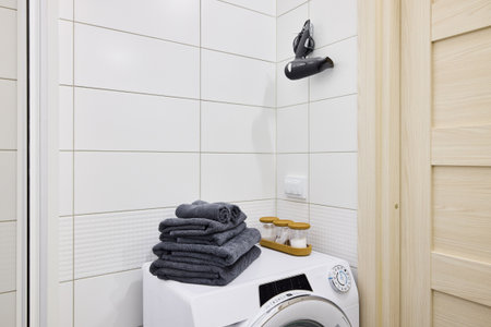 A Contemporary and Modern Laundry Space Featuring Soft Towels and a Functional Washerの写真素材