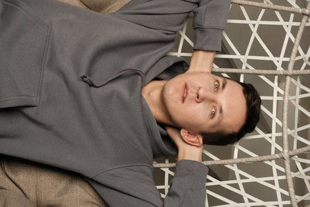 A Casual Portrait Depicting a Young Man Who Is Enjoying a Relaxing Day Indoors Within His Home