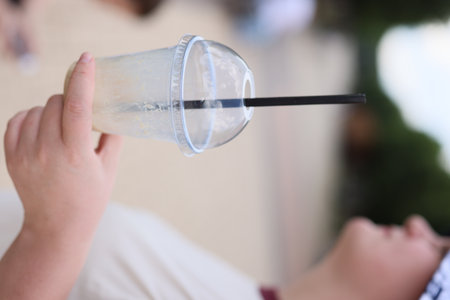 With a refreshing summer drink in hand, I am enjoying the beach and all its delightsの写真素材