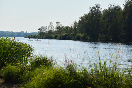 A Serene River Landscape featuring Lush Greenery alongside Adventurous Kayakers
