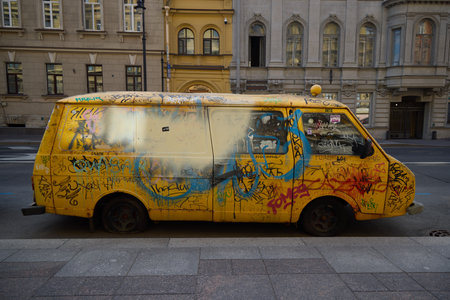 A beautiful and vibrant display of colorful urban art painted on a vintage yellow vanの写真素材