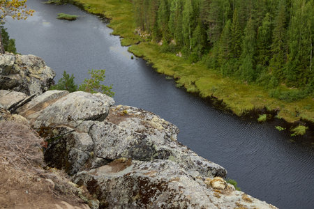 A Beautiful Serene River Landscape Featuring a Rocky Outcrop Surrounded by Lush Greenery