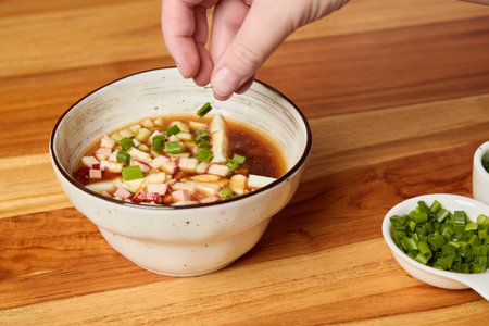 Enhancing a Flavorful Sauce Presentation by Garnishing with Fresh Green Onions for Appealの写真素材