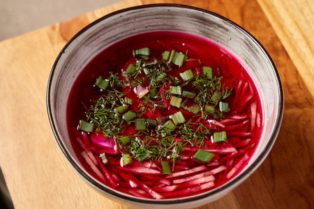 Indulge in a Vibrant Beetroot Soup made with Fresh Herbs and Green Onions for flavor