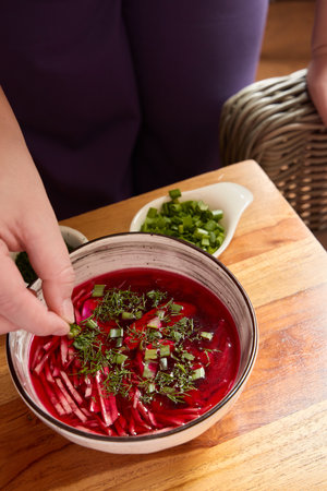 A Stunningly Vibrant Beetroot Soup Enhanced with Fresh Herbs and Greens for Flavor