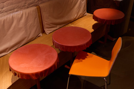 A Stylish Cafe with EyeCatching Seating Featuring Vibrant Tables and Charming Chairsの写真素材