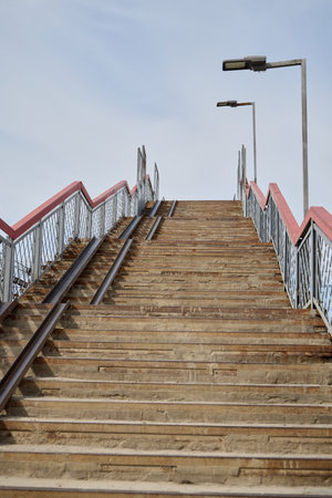 Beautiful Wooden Steps Leading Upwards, Complete with Railings and Street Lights Lighting the Wayの写真素材