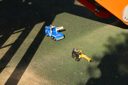 Brightly Colored Toy Trucks on the Playground Surface Ready for Fun and Adventureの写真素材