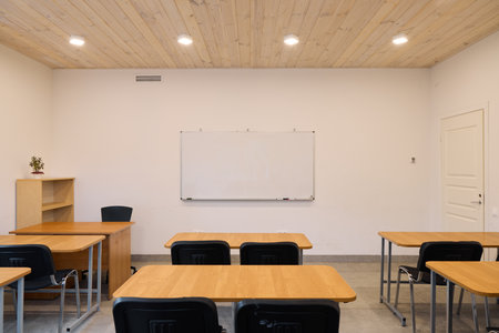 A Contemporary Classroom Featuring a Beautiful Wooden Ceiling and Stylish Desks for Learningの写真素材