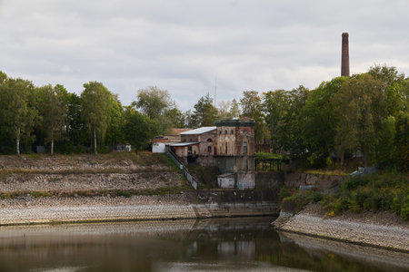 A Historic Industrial Building Located by the Waters Edge, Showcasing Unique Architectureの写真素材
