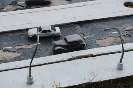 Miniature Vintage Cars arranged beautifully on a Weathered Road Scene that tells a story