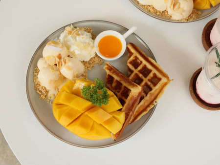 Indulge in a Delicious Mango Waffle Breakfast that is perfectly paired with Ice Creamの写真素材