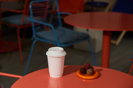 A cozy cafe offers a delightful array of coffee and tasty treats on a colorful table