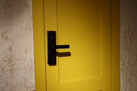 An EyeCatching Yellow Door Featuring a Modern Handle Design That Effectively Attracts Attention