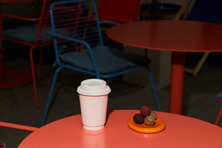 A stylish coffee cup with a dessert is elegantly set on a modern table for enjoymentの写真素材