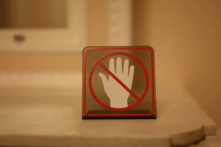 No Entry Hand Sign Displayed on a Surface Indicating Restricted Access or Prohibitionの写真素材