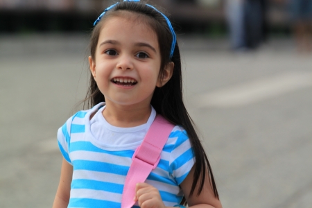 Happy little girl in the streetの写真素材