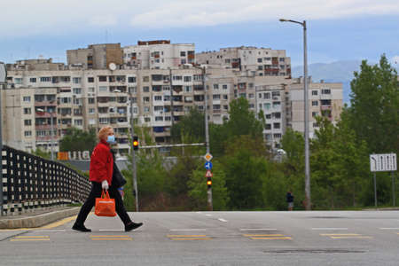 Sofia, Bulgaria â May 2, 2020: COVID-19 Pandemic Coronavirus. Woman on city street wearing face mask protective for spreading of disease virus SARS-CoV-2.のeditorial素材