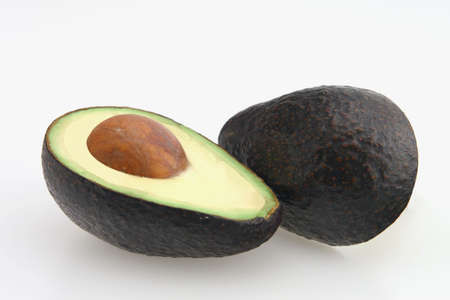 Avocado sliced in half with seed in center