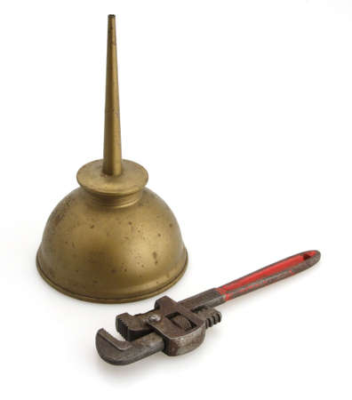 Old vintage pipe wrench red handles with oil can