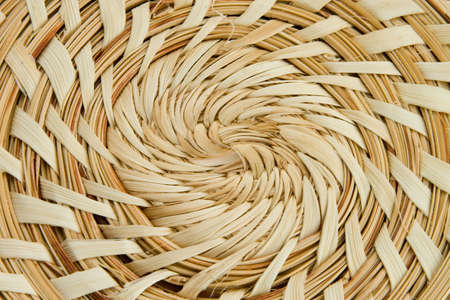 Tan woven swirl straw texture close abstract