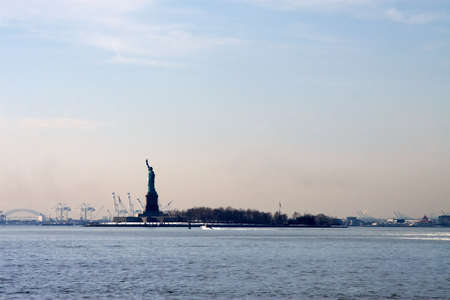 Statue of Liberty in the waters of New York Harbor の写真素材