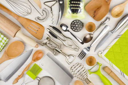 Background of kitchen utensils on wooden kitchen table