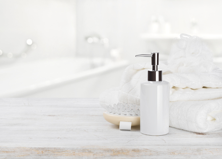 Soap dispencer, towels, massager and wisp of bast over blurの写真素材