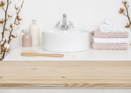 Wooden table top and blur bathroom interiorの写真素材