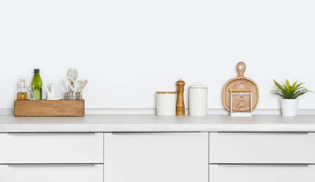 Contemporary utensils and spices standing on kitchen countertop with spaceの写真素材