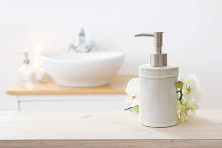 White folded spa towel and orchid flowers on wooden tableの写真素材